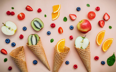 Fototapeta na wymiar Cones and colorful various fruits raspberry ,blueberry ,strawber