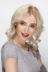 White hair fashion model with natural makeup, blue eyes and red