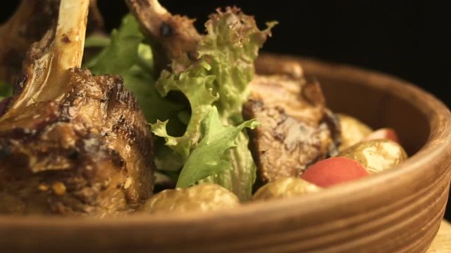 Rotating plate with asian red sause ribs and vegetables