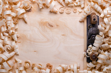 wood shavings on a wooden background with tools