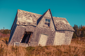 crooked leaning old house with vintage filter