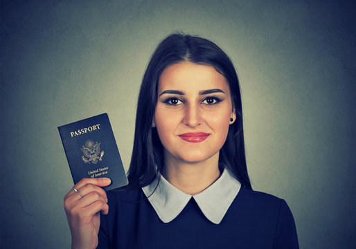 Portrait attractive young happy woman with USA passport