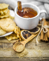 delicious cookies and Cup of hot tea with a cinnamon stick