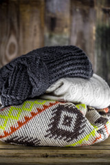 Sweaters on wooden background