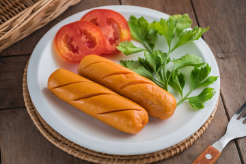 Grilled sausage with vegetables on plate