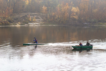 rowing and canoe float down the river in autumn