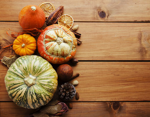 Seasonal wooden table setting with small pumpkins