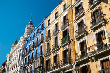 Fototapeta na wymiar Mediterranean architecture in Spain. Old apartment buildings in famous Calle Mayor in Madrid.