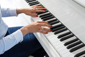 Woman playing white piano