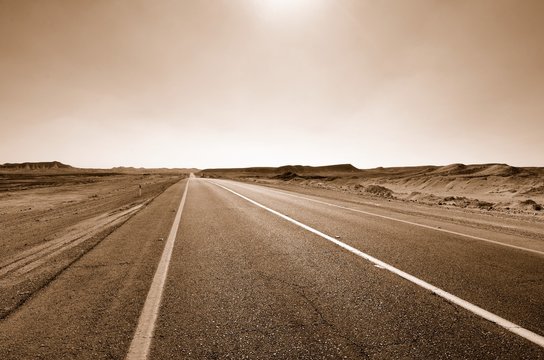 Road in the desert. Sepia