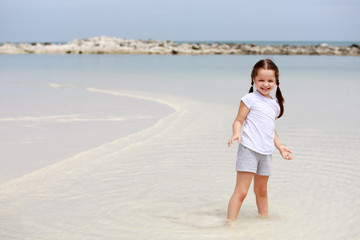 little girl have fun on the beach
