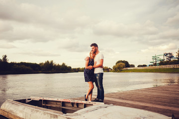 romantic couple standing on the pier
