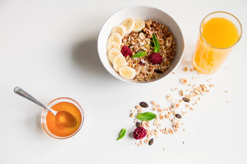 Breakfast with oatmeal and orange juice on white background