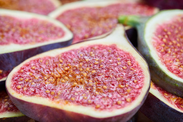 Pieces of fig on a stone board. Fruit background