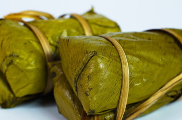 Porridge tie. Sticky rice wrapped in banana leaves, banana banana filling, steamed cooked food.
