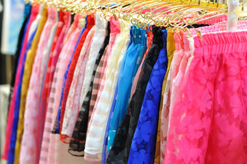 Color mini skirts hanging for sale