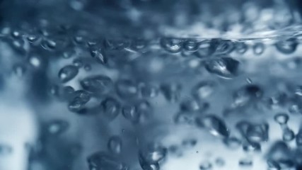Close up of carbonated water producing gas bubbles as it being poured into glass - Powered by Adobe
