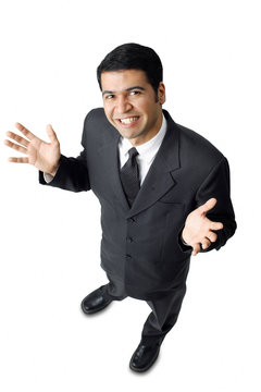 Businessman, hands raised, palms facing up, looking at camera