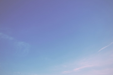 Clear blue sky with light white clouds Vintage Retro Filter.