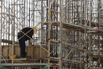 Construction worker in building frame.
