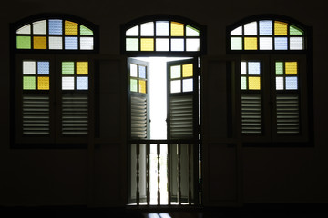 Light coming through old shop house stained glass windows.