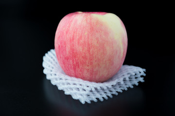 fresh apple on a protective foam on black background