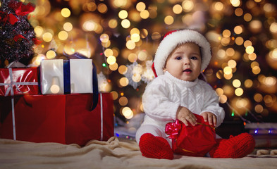 Little boy in Christmas Santa's hat. Against the backdrop of a C