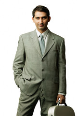 Businessman carrying briefcase, hand in pocket, facing camera