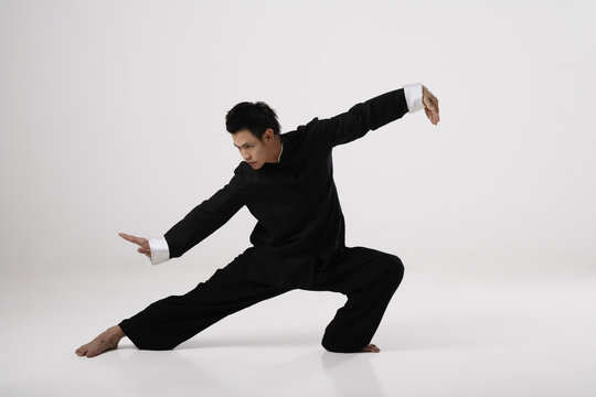 Man doing Tai Chi wearing traditional Chinese clothes