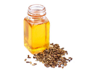 Thistle oil in bottle and seeds