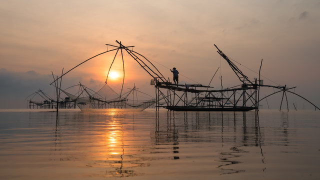 Fisherman with giant square dip net at Pakpra canal, Phatthalung, Thailand.