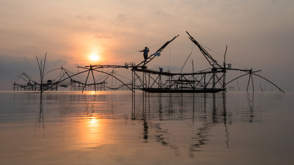 Fototapeta premium Fisherman with giant square dip net at Pakpra canal, Phatthalung, Thailand.
