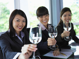 Three woman toasting the camera