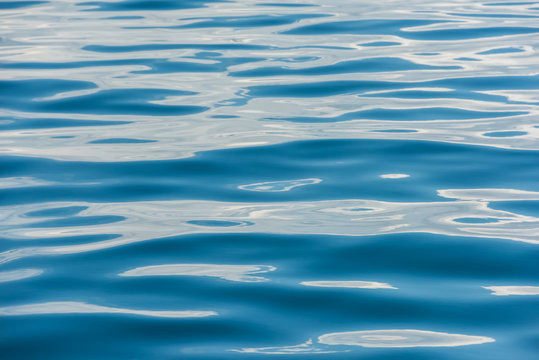 Fototapeta The water surface of the ocean in the form of light blue and blue strips off the coast of Singapore
