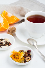 a mug of tea, oranges and sugar