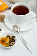 cup of tea, sugar and oranges