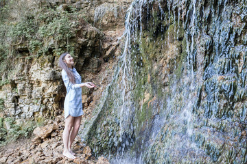 woman walking near the mountain waterfalls