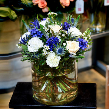 Bouquet With White And Blue Flowers In A Glass Vase