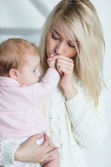 mother puts her baby daughter to sleep