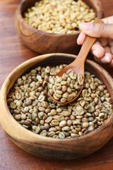 Coffee beans on wooden spoon for background