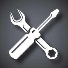 Simple vector icon of a screwdriver and a wrench on a dark gray background. Hand tools for repair and construction