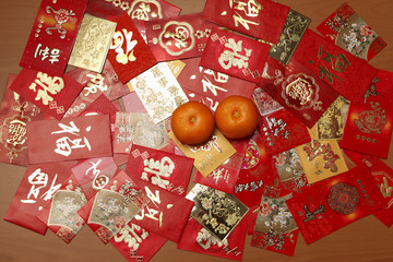 Man different Hong Baos, red envelopes with oranges.