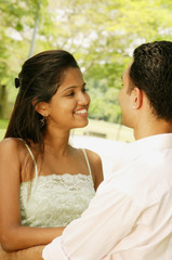 Couple standing, looking at each other, portrait