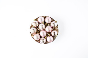 round box with bright christmas balls on white background. flat lay, top view