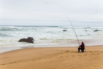 Lonely fisherman on the Atlantic ocean coast in Alentejo, Portugal