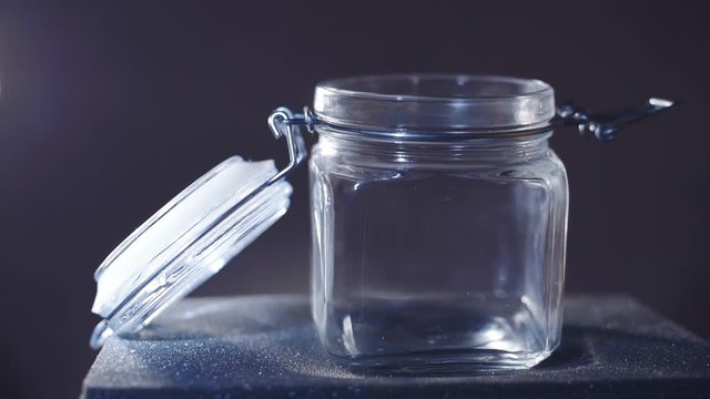 glass jar on a dark background with light