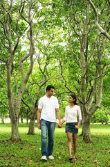 Couple walking in park, holding hands