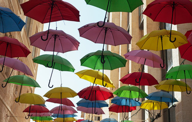 Fototapeta na wymiar Multicolored umbrellas on the street.