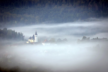 Church   hiding in the early morning fog