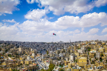 Amman city center and Jordanian flag in the middle - obrazy, fototapety, plakaty